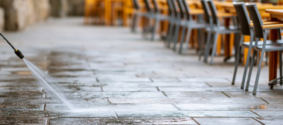Pressure washing a restaurant outdoor dining patio and walkway